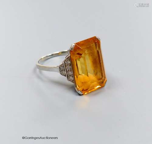 A white metal and emerald cut yellow topaz set dress ring, w...