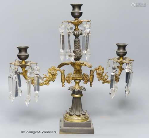 A 19th-century French bronze and ormolu three light candelab...