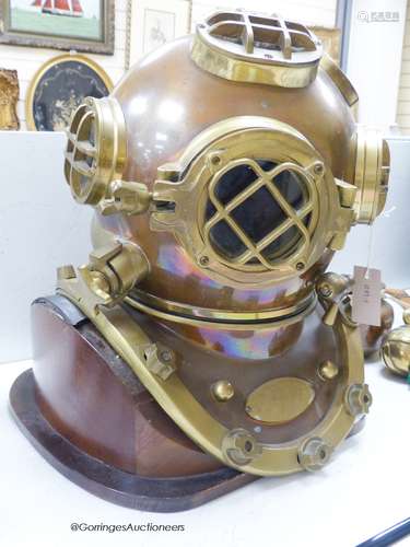 A copper and brass full size model of a diver's helmet, moun...