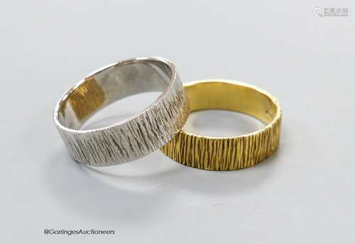 A modern textured 18ct gold band, size S, 5 grams and a simi...