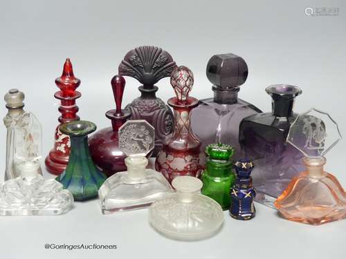 A collection of 1920's and earlier glass scent bottles to in...