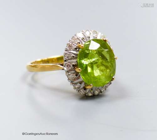 An 18ct, peridot and diamond oval cluster set dress ring, si...