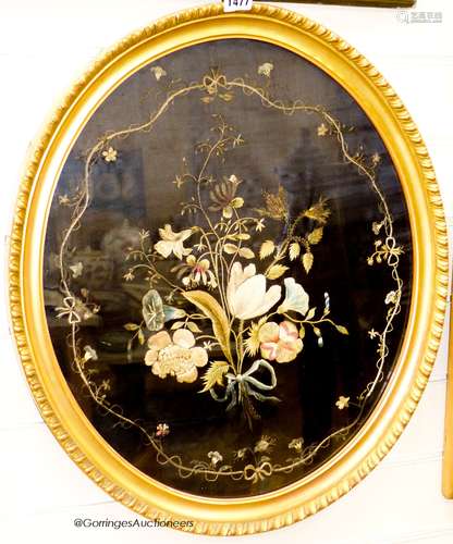 A 19th century silk embroidery of flowers on black silk back...