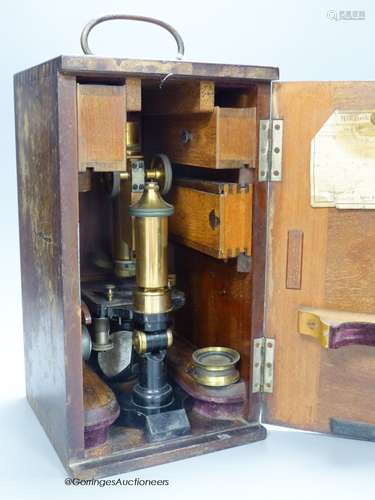 A lacquered brass microscope with lenses by E. Leitz, boxed