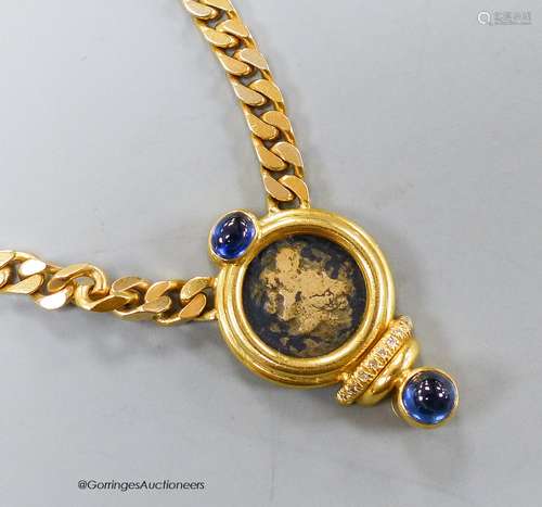 A modern curb link yellow metal, inset coin, blue cabochon s...