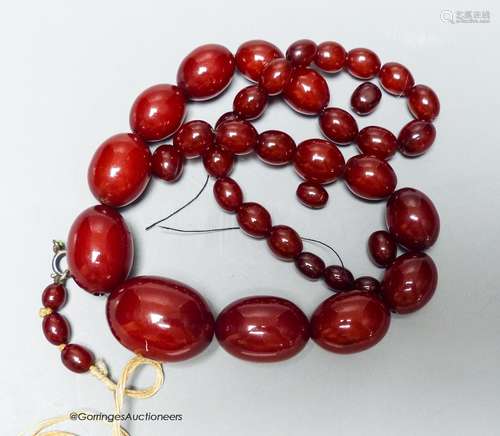 A single strand graduated simulated cherry amber necklace (a...