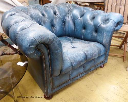 Victorian style, buttoned blue leather chesterfield armchair...