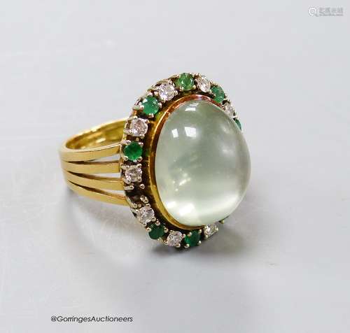 A modern 750 yellow metal, pale green cabochon stone, emeral...