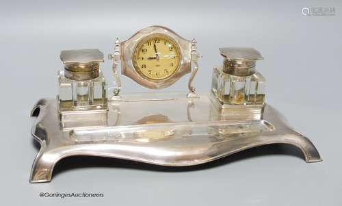 A George V silver desk standish with two silver topped inkwe...