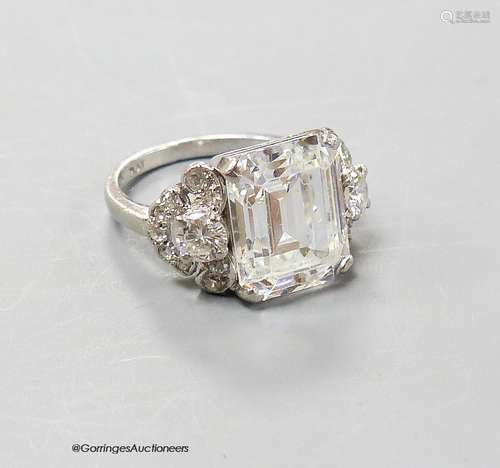 A platinum and emerald cut simulated diamond dress ring, wit...