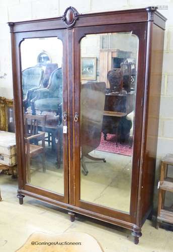 An early 20th century continental mirrored mahogany wardrobe...