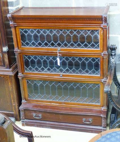 A Globe Wernicke serpentine mahogany four section bookcase. ...