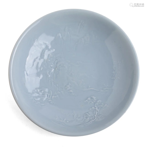 A BLUE-GLAZED LOW RELIEF 'LANDSCAPE' DISH