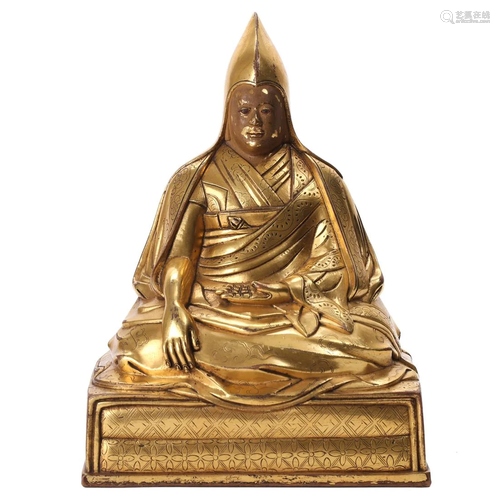 A TIBETAN GILT-BRONZE FIGURE OF A LAMA