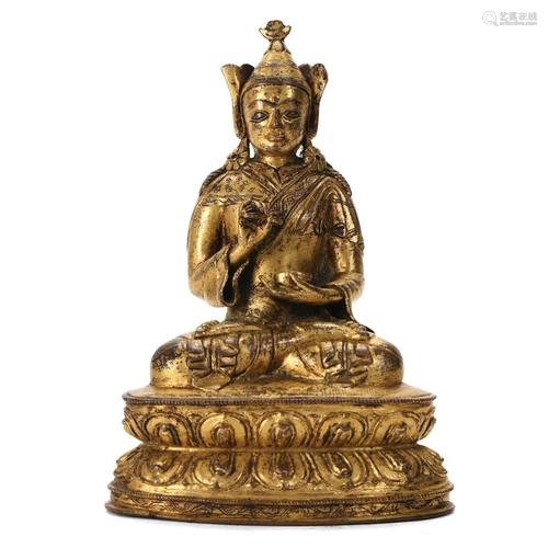 A GILT-BRONZE FIGURE OF A LAMA