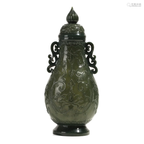 A SPINACH-GREEN JADE VASE WITH HANDLES