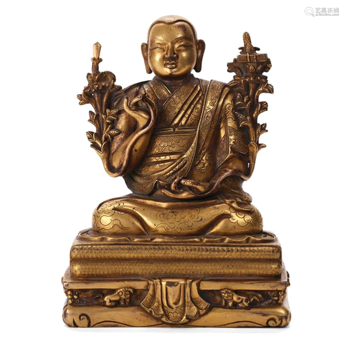 A GILT-BRONZE FIGURE OF A SEATED LAMA