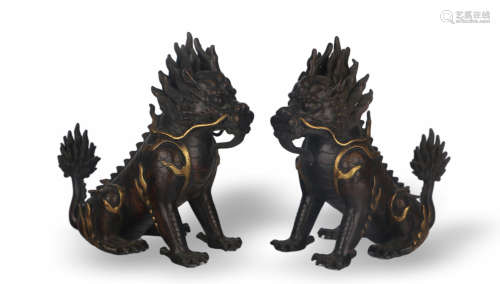 A PAIR OF GILT COPPER BODIED KYLIN ORNAMENTS