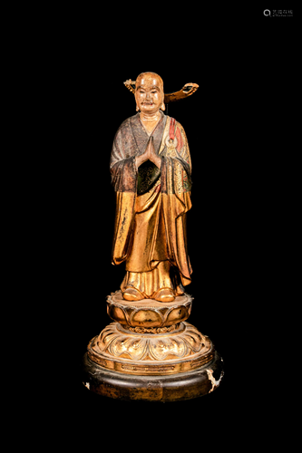 A Polychrome and Gilt Painted Wood Figure of a Standing