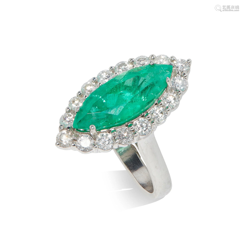 An emerald and diamond cluster ring