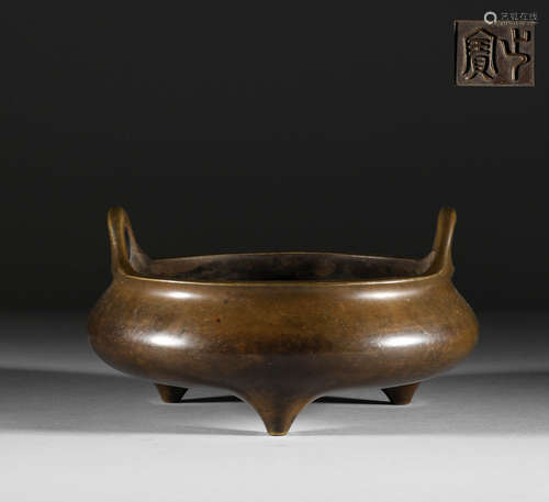 In the Ming Dynasty, a copper three legged double ear stove