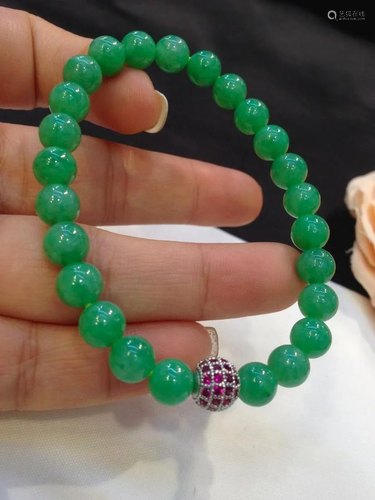 A Chinese Carved Jadeite Bracelet