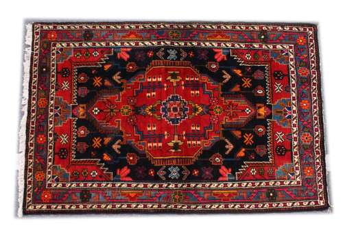 A GOOD PERSIAN RUG, 20TH CENTURY, red ground with stylised d...