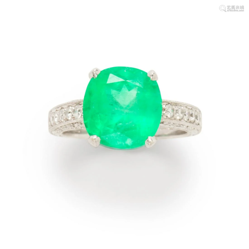 An emerald, diamond and eighteen karat white gold ring