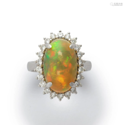 An opal, diamond and fourteen karat white gold ring
