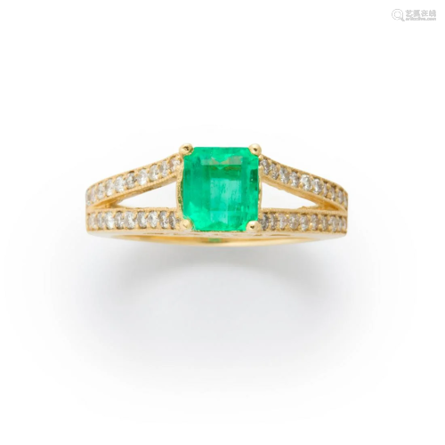 An emerald, diamond and fourteen karat gold ring