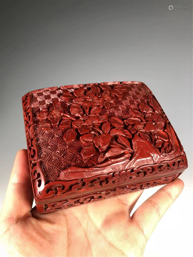 A CARVED RED LACQUER FLORAL BOX AND COVER