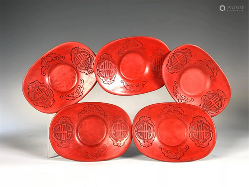 FIVE CARVED RED LACQUER INGOT-SHAPED TEA SAUCERS