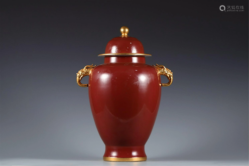 A RED GLAZE DOUBLE-HANDLED VASE AND COVER