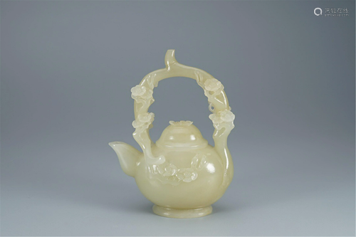 A CARVED PLUM BLOOMS JADE POT WITH LOOP HANDLE