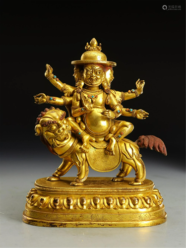 A GILT BRONZE DHARMAPALA