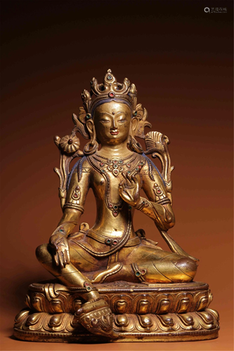 A BRONZE GILT SEATED GREEN TARA