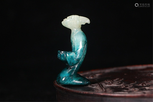 A JADE CARVING OF A KNEELING FIGURE