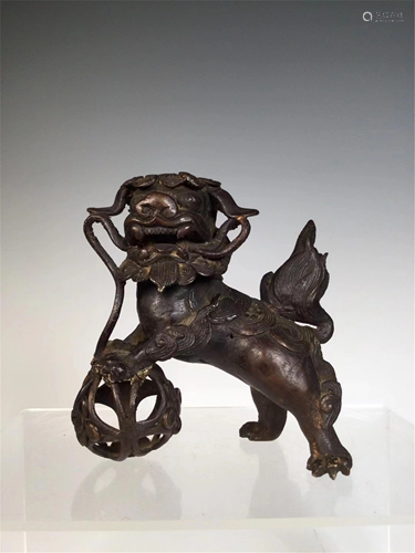 A BRONZE DECORATION OF LION AND A BALL