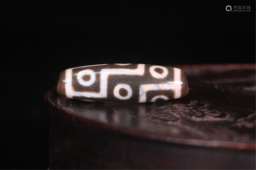 A NINE-EYED DZI BEAD