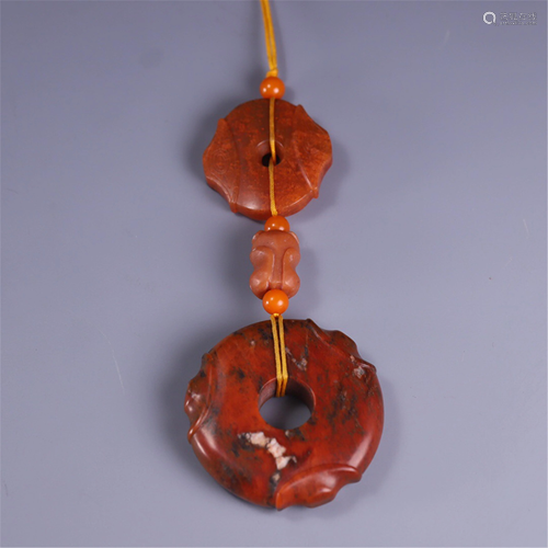 A STRING OF JADE CARVED PENDANTS