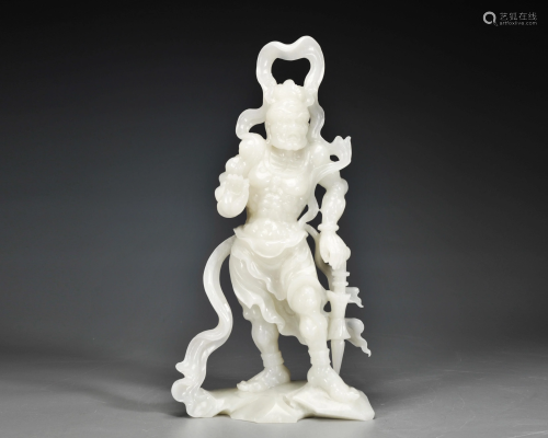 A Carved White Jade Standing Guardian Qing Dynasty
