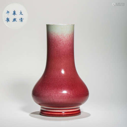 A RED-GLAZED LONG-NECKED VASE, THE KANGXI PERIOD OF THE QING...