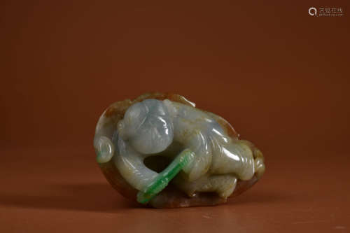 A MOTTLED JADEITE CARVING OF BOY AND BULL