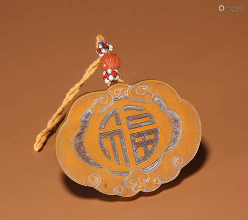 A CARVED BAMBOO RUYI-FORM PENDANT