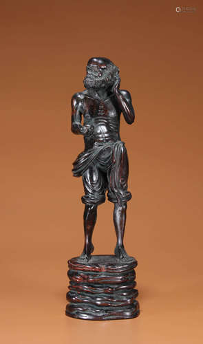 A SANDALWOOD CARVING OF DHARMA