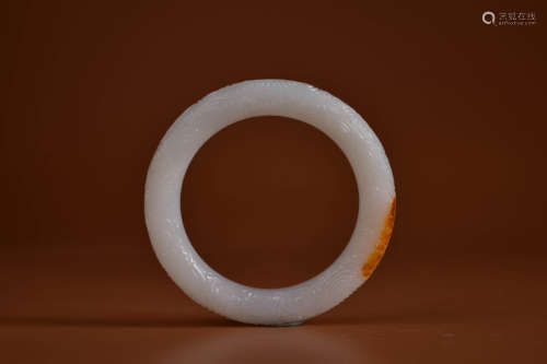 A HETIAN WHITE AND RUSSET JADE CLOUD BANGLE