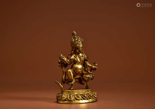 A GILT BRONZE FIGURE OF JAMBHALA