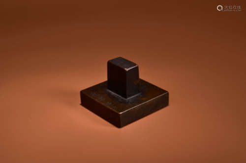 A BRONZE SQUARED STAMP