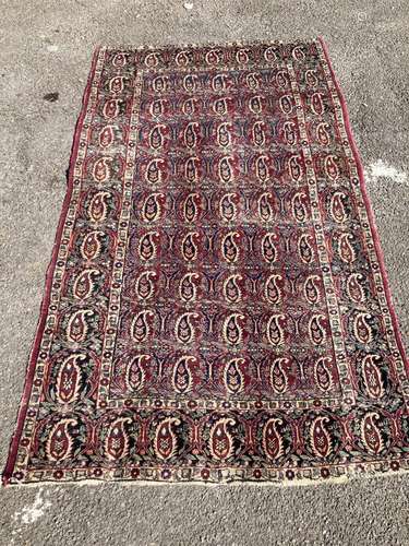 An early 20th century Persian Senneh red ground rug woven wi...