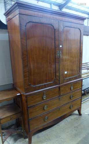 A George IV mahogany linen press, with a pair of hinged pane...